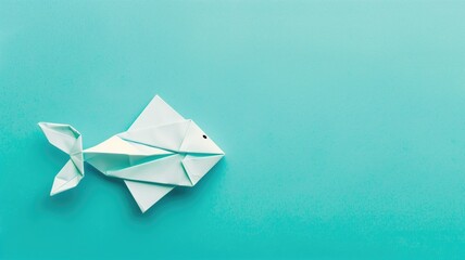 Origami fish on turquoise background