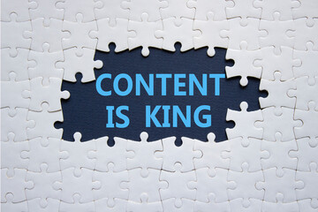 Content is king symbol. Concept words Content is king on white puzzle. Beautiful deep blue background. Business and Content is king concept. Copy space.