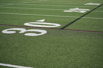 30 thirty yard line on an outdoor green and white football field