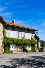 Maison de la ville basse de Saint-Bertrand-de-Comminges à la façade recouverte de plantes grimpantes