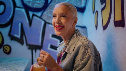 Stylish grandmother enjoying music in bar closeup. Happy pensioner dancing cafe