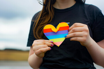 Lesbian Girl Holding Rainbow Heart for Equality
