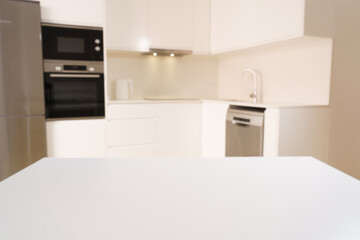 white table on the background of a white kitchen, background for placing a product on it