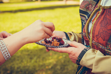 Female hand holding luxurious medieval plate with sweets