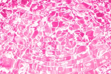 transparent blurred pink water texture with sunlight reflection. clean water surface with calm...