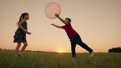 Girl Child Boy Kid playing big ball sunset, children dream flying, happy family, teamwork true...
