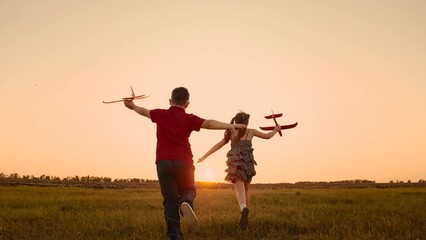 happy boy girl child play airplane pilot sunset, children family dream flying, children run...