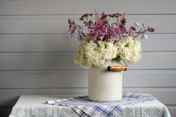 Bouquet Of Garden Flowers: White Hydrangea, Hosta and Yarrow In Interior Of Cottage On The Table.