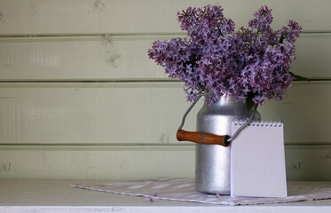 Spring Mockup with Purple Lilac and Notebook With Empty Cover. Copy space.