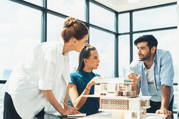 Professional diverse architect engineer team working together to design house model. Group of...