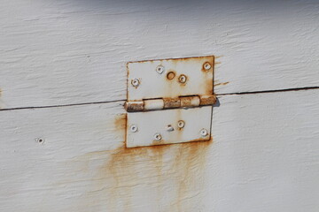 Rusty Hinge on White Painted Wood Door Stock Photo