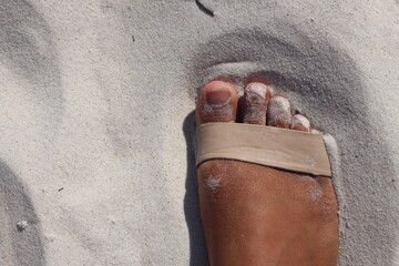 Female feet with toes in the sand stock photo