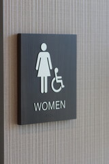 Women's Bathroom ADA Signage with Wheelchair Symbol - Stock Photo
