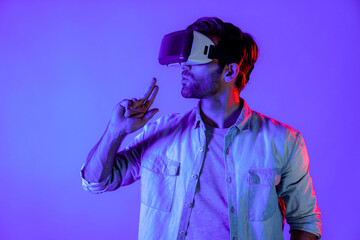 Caucasian smart man wearing VR glass and moving gesture holding gun. Gamer using future digital...