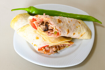 Lavash doner kebab ( zurna et tavuk doner durum )  or shawarma sliced in plate isolated. 