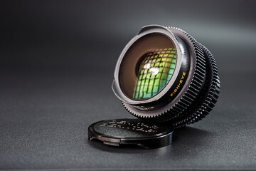 Tilted view of a fisheye lens showing colorful light refractions, yellow fisheye text, essential...