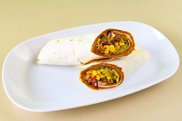 Cig kofte (raw meatball) with lettuce, tomato, pickle and lemon, hot Chee kofta. Turkish local raw food concept. Table scene of assorted take out or delivery foods. Top view of assorted Turkish food.