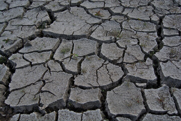 Closeup view of the dry cracked riverbed near Sparth Reservoir in Marsden, Yorkshire.
