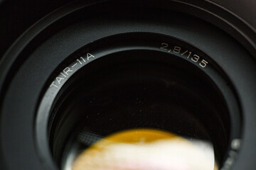Detailed view of TAIR-11A camera lens engraving, with focal length and aperture value, precision...