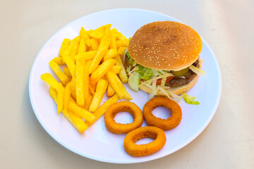 Big tasty burger with beef cutlet on a plate. Hamburger, cheeseburger with mushroom. Hamburger, Mexica, mushroom double burger.  Crispy chicken burger. With french fries, patates kizartmasi.