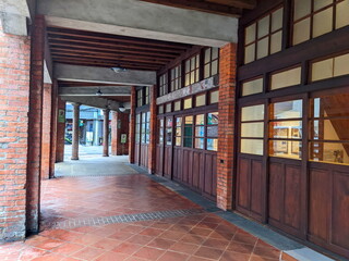 Taipei, Taiwan - 11.23.2022: An empty veranda with red-brick columns, concrete structures, and red...