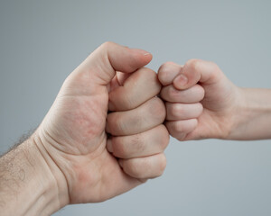 Little girl and her newborn brother hiding under the blanket. 