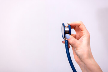 Close up of woman doctor hand holding stethoscope