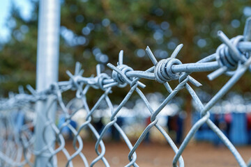A chain link fence with barbed wire on top