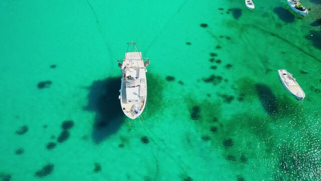 Small fishing boats anchoring in crystal clear sea water on Rab island, Croatia