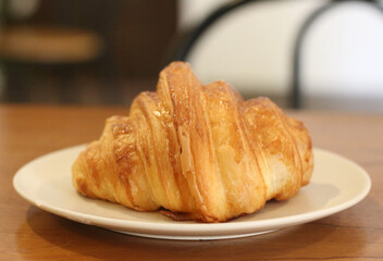 croissant on a plate on a table.