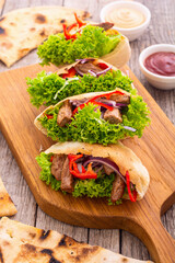 Pita with salad , paprika and beef meat . Traditional arabian and israel food