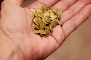 Close up of organic sunflower seeds cupped in the palm of a hand