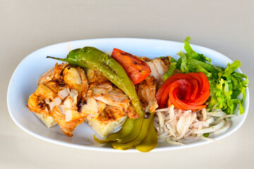 Turkish and Arabic Traditional Ramadan doner kebab with tasty tomato sauce and rice or turkish pilav in white plate on wood table background. ( Pilav ustu doner). Ekmek arasi doner, doner durum. 
