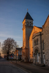 Fototapeta na wymiar Bell tower of a church illuminated during a sunset