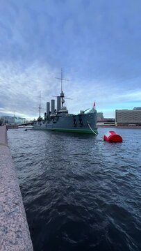 St. PETERSBURG, RUSSIA - April 20, 2024: The Aurora Cruiser Museum on the Neva River on a 20th-century warship. View of the cruiser Aurora, a historical warship, now a war memorial museum. 4К