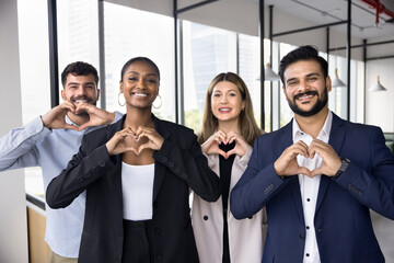 Multiethnic business team of happy coworkers in formal clothes making hand heart gesture, promoting...