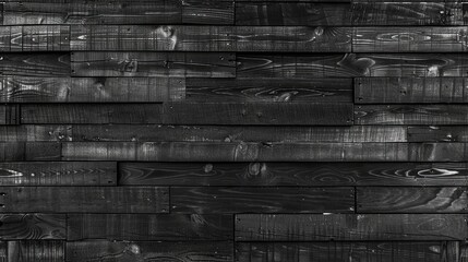 A black wooden wall with a black and white background. The wall is made of wood and has a very dark color
