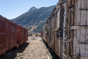 old train cars in a railway station in the mountains