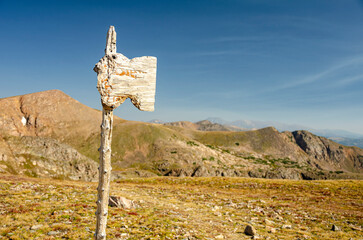 worn trail sign on a high alpine mountain trail