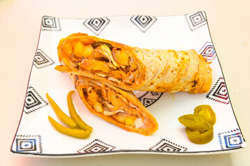 Lavash doner kebab ( zurna et tavuk doner durum )  or shawarma sliced in plate isolated. 