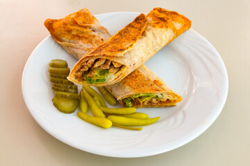 Lavash doner kebab ( zurna et tavuk doner durum )  or shawarma sliced in plate isolated. 