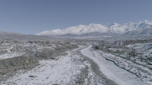Vista de r&iacute;o congelado con monta&ntilde;as nevadas desde el aire