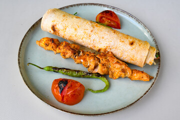 Lavash doner kebab ( zurna et tavuk doner durum )  or shawarma sliced in plate isolated. 