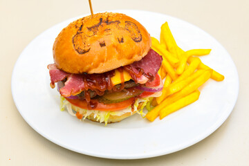 Big tasty burger with beef cutlet on a plate. Hamburger, cheeseburger with mushroom. Crispy chicken burger.