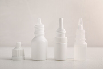 Bottles of medical drops on white background