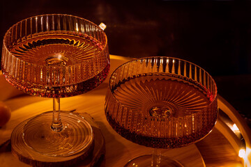 Close-Up of two glasses of tincture rowan on cognac in champagne coupe glasses, low key. Delicious...