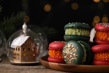 Beautifully decorated Christmas macarons and festive decor on wooden table, closeup