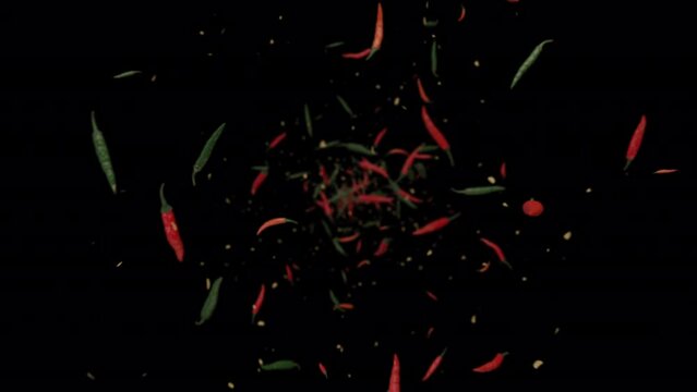 3D animation of red, green, and seeds of chili exploding to the camera and spinning in slow motion included alpha matte. 
