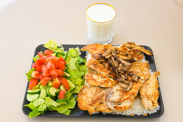 Turkish and Arabic Traditional Ramadan doner kebab with tasty tomato sauce and rice or turkish pilav in white plate on wood table background. ( Pilav ustu doner). Ekmek arasi doner, doner durum. 