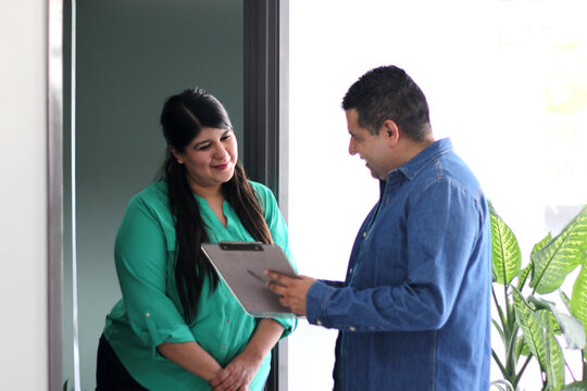 Dark-skinned Latino man surveyor visits house to house to ask questions to residents and make statistics